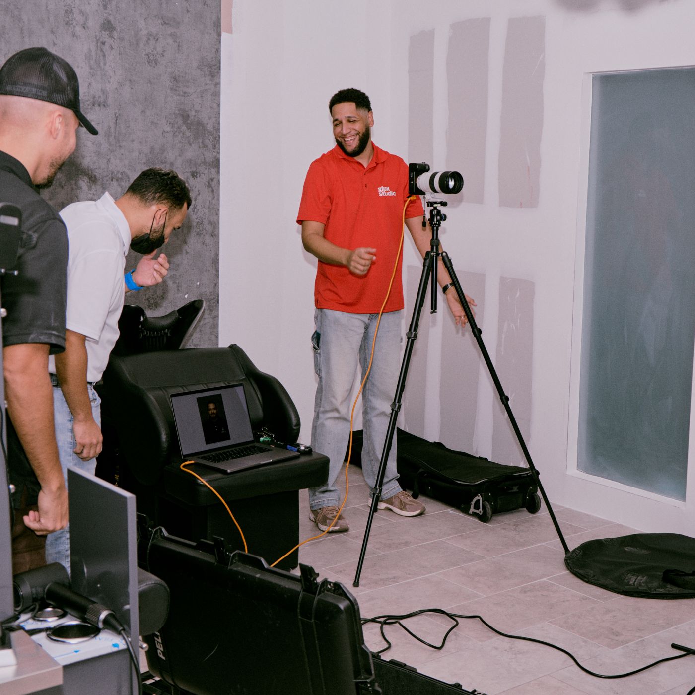 Gerson setting up lights and camera on a commercial photo set