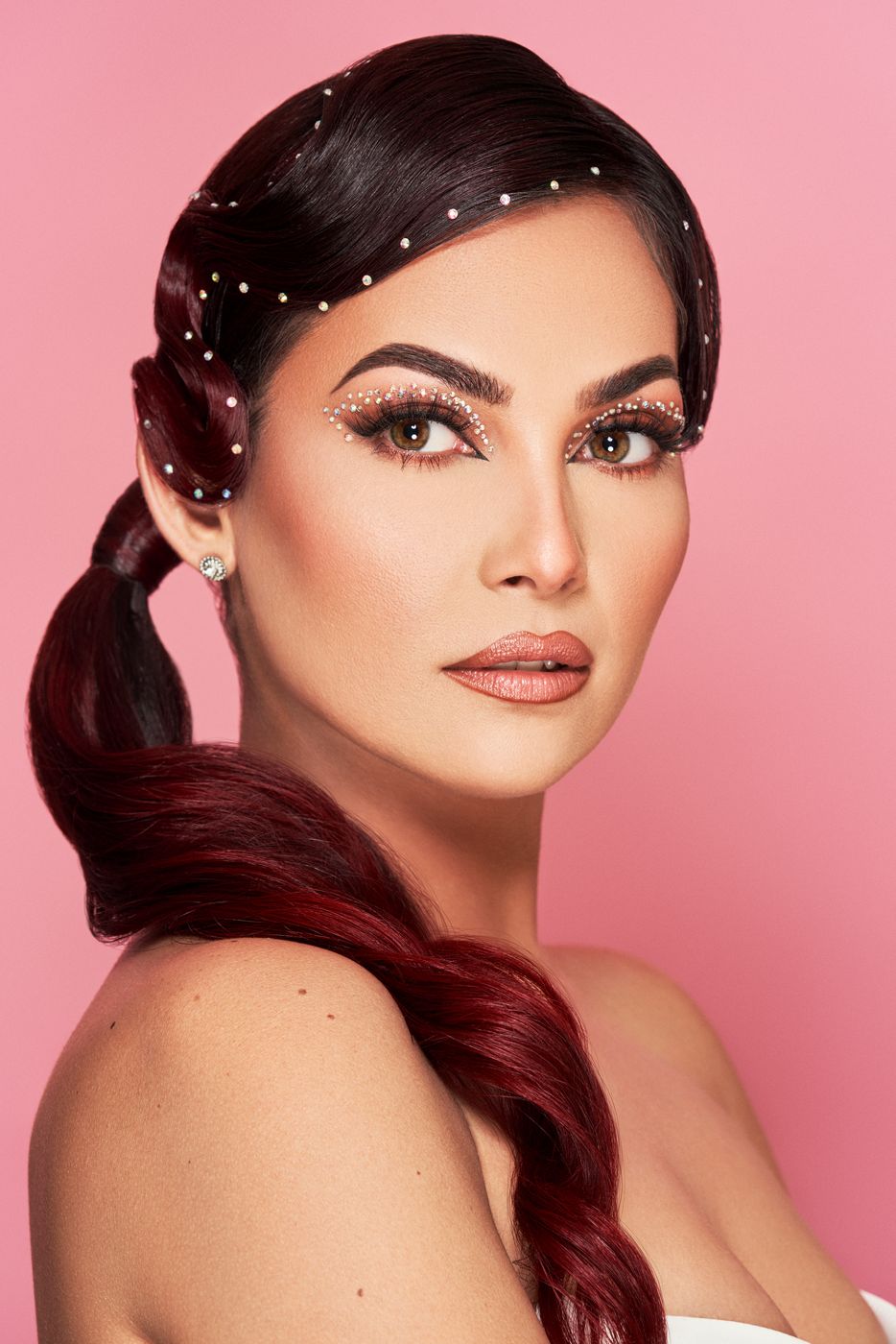 Beauty portrait with pearl hair accessories on pink
