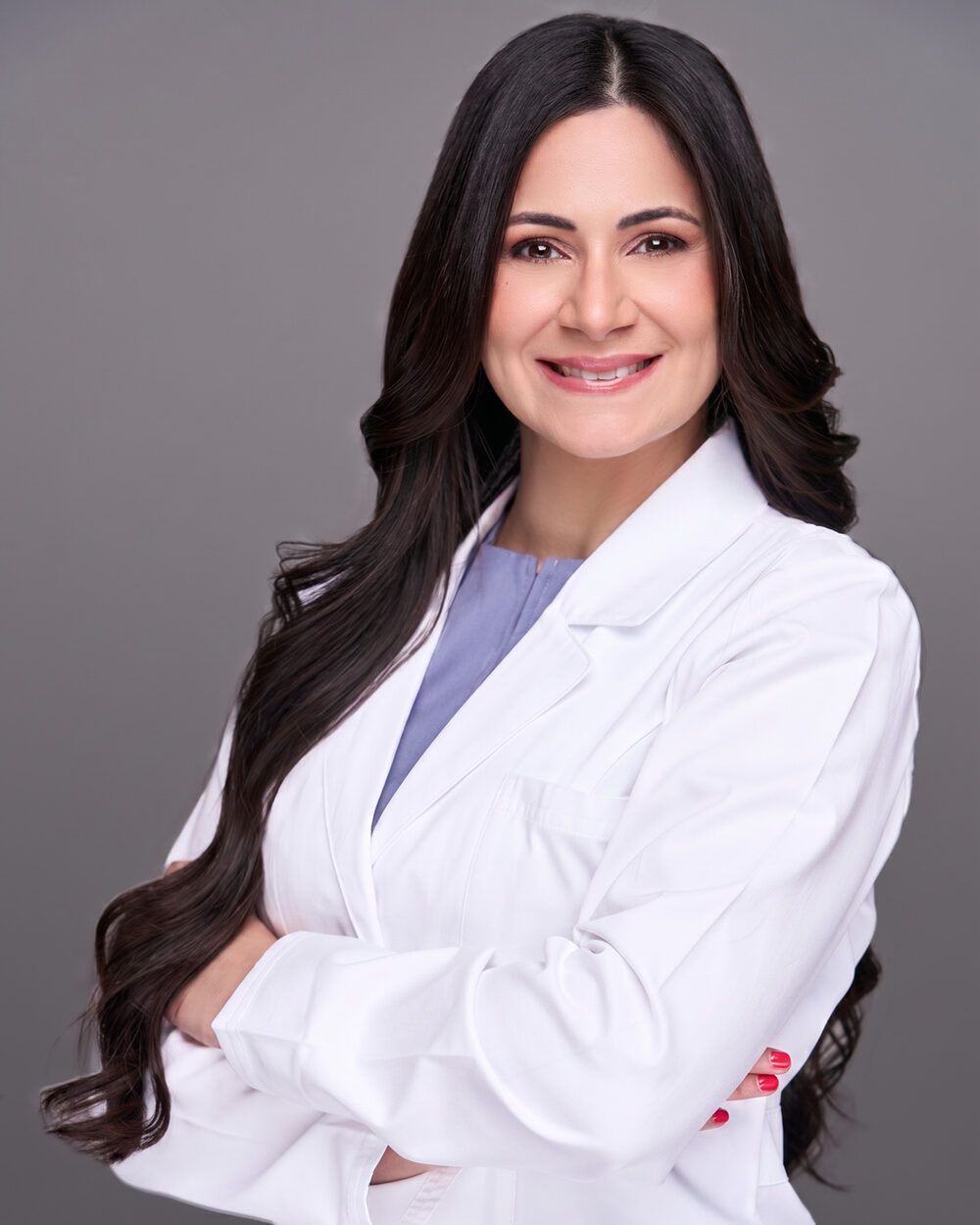 Smiling doctor in a white coat with arms crossed