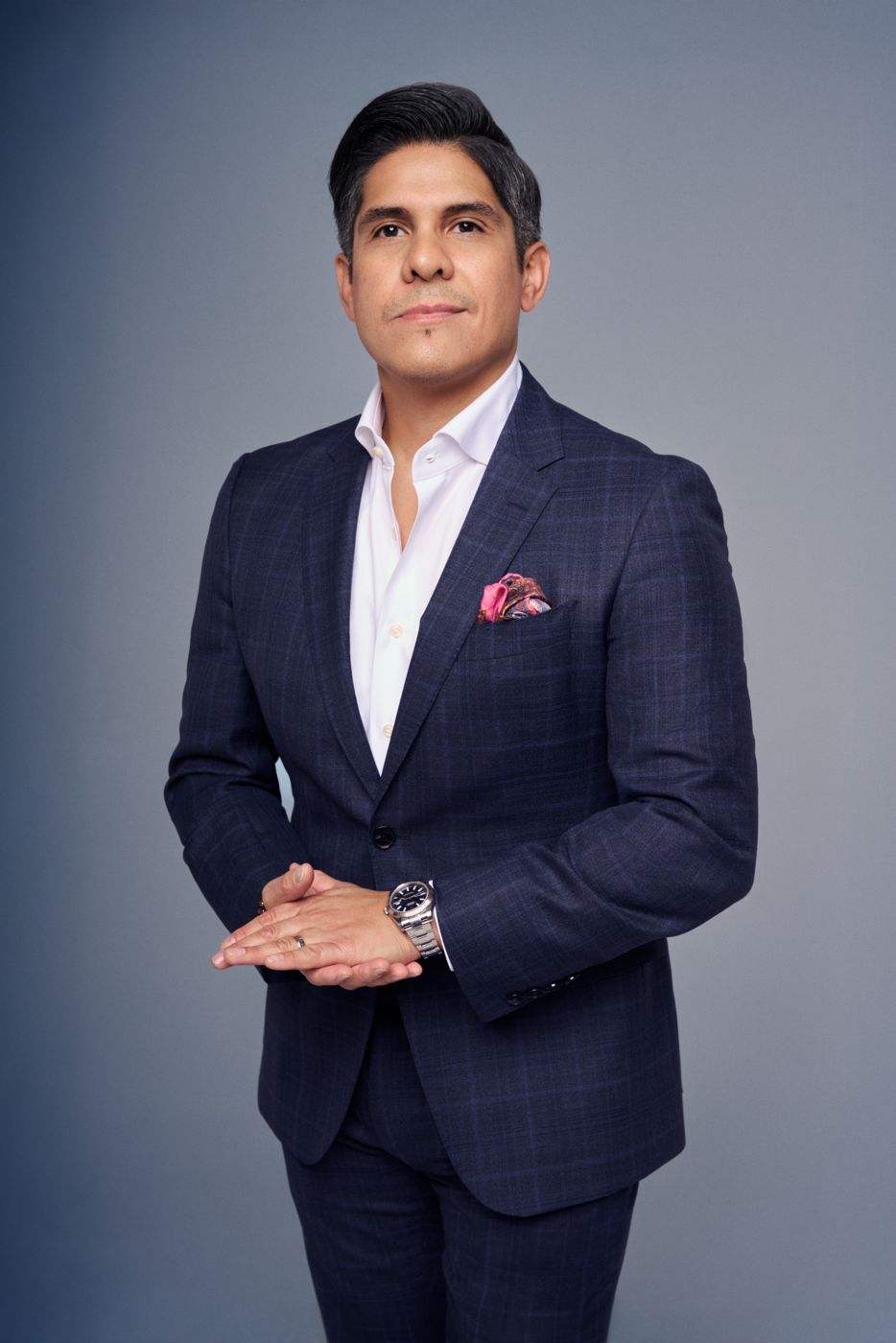 Man in a navy check suit with a pocket square