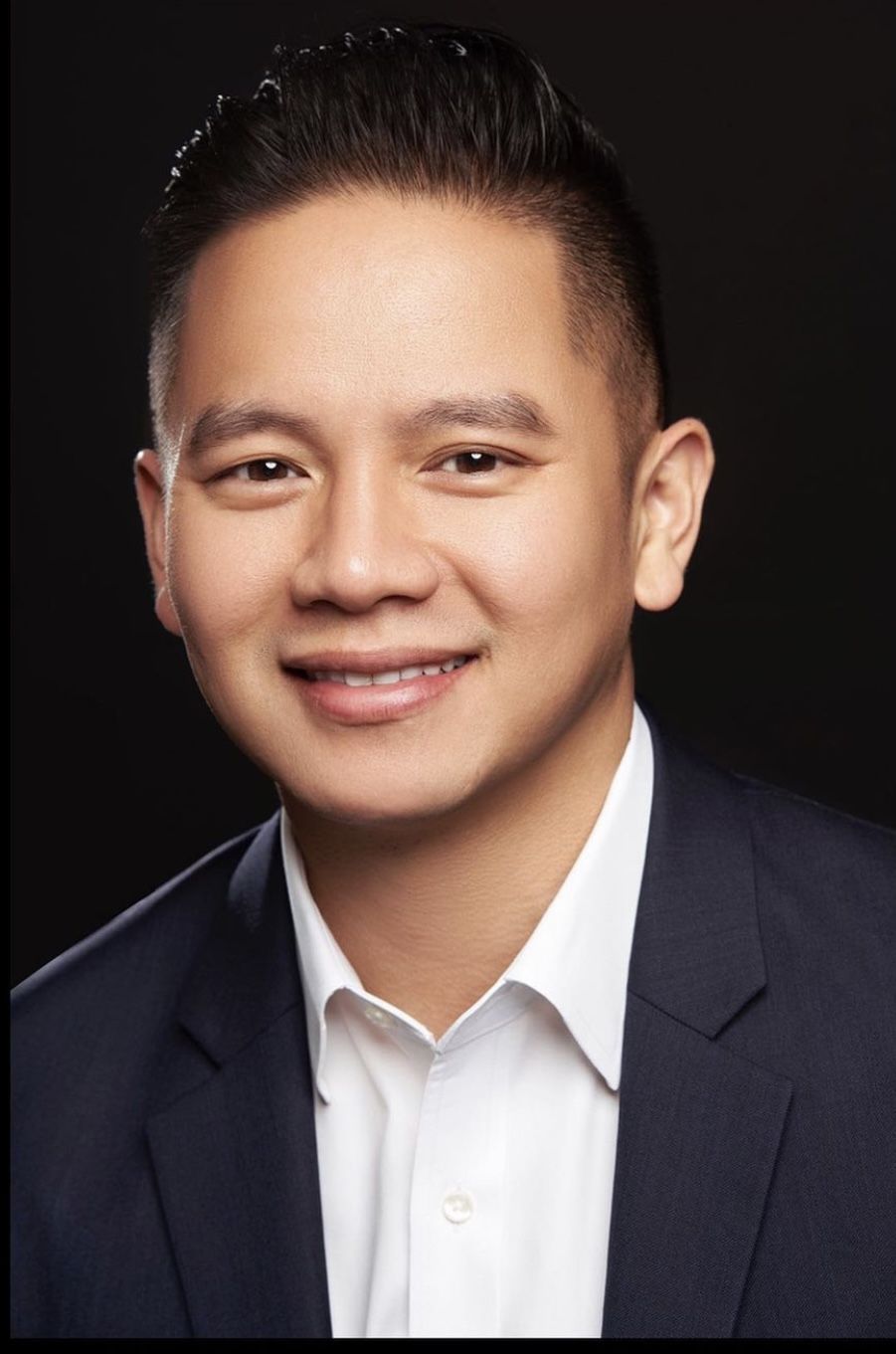 Smiling professional in a navy suit and white shirt