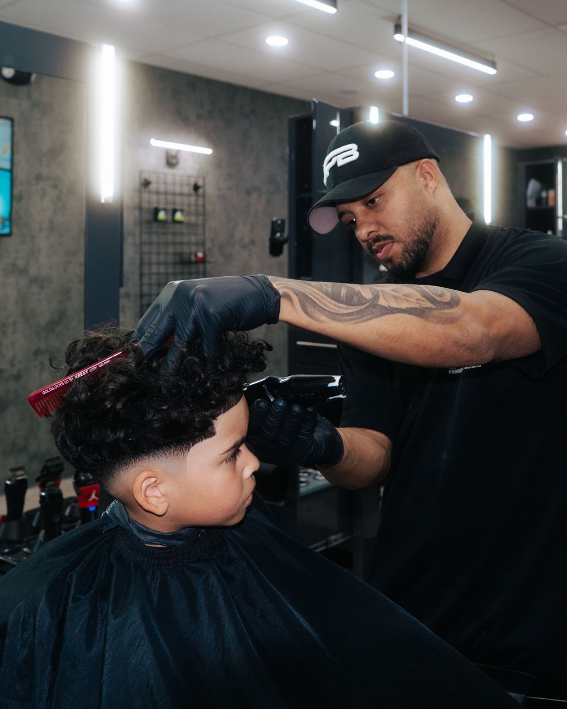 Jestic barber cutting a client's hair in the shop