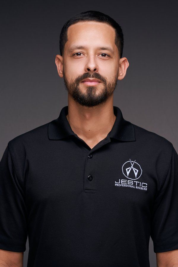 Barber with a beard in a black Jestic polo